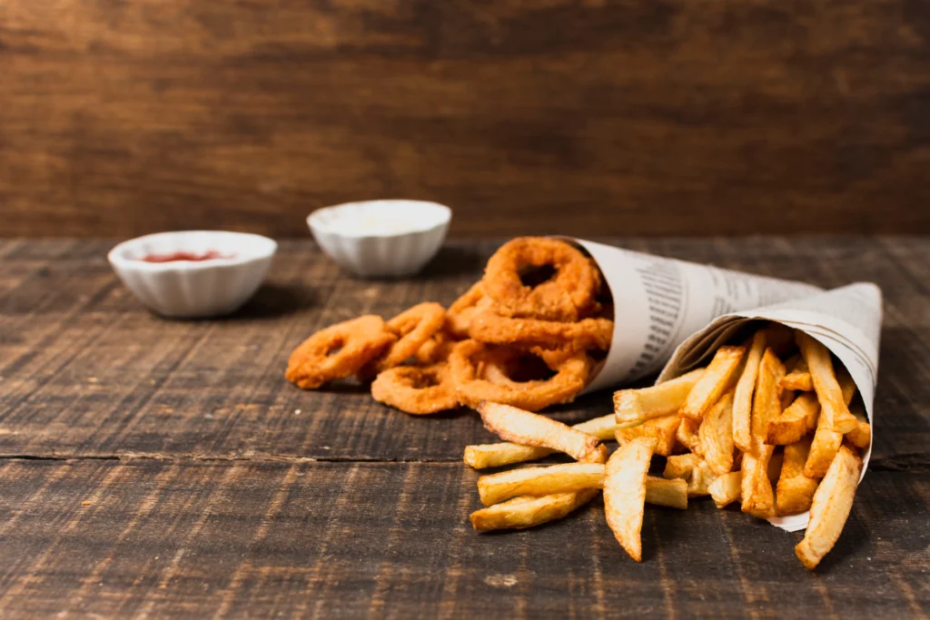 A plate of Onion French Fries with a side of ketchup, showcasing their crispy texture and wavy shape.