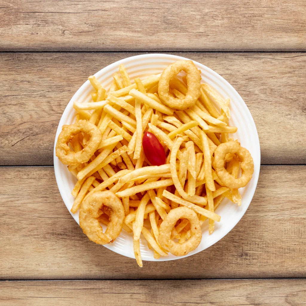 A plate of Onion French Fries with a side of ketchup, showcasing their crispy texture and wavy shape.