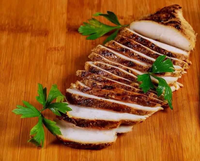 Juicy and perfectly grilled pellet grill chicken breast served with herbs and spices.