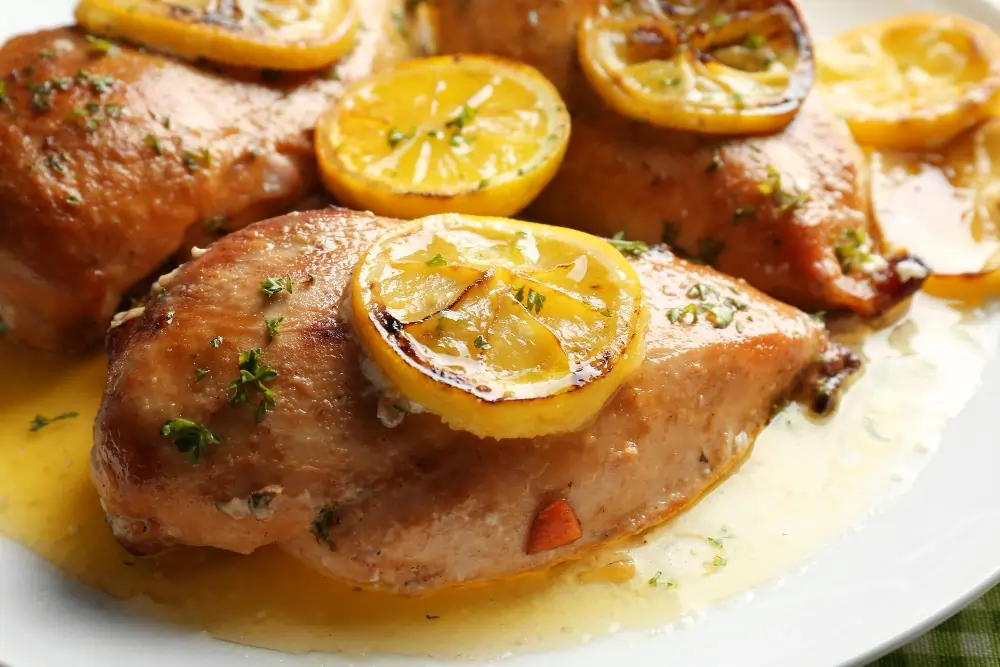 Lemon Pepper Chicken Thighs: A beautifully plated dish of lemon pepper chicken thighs, garnished with fresh herbs and lemon slices, showcasing a vibrant and appetizing meal.