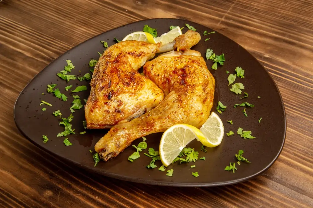 Lemon Pepper Chicken Thighs: A beautifully plated dish of lemon pepper chicken thighs, garnished with fresh herbs and lemon slices, showcasing a vibrant and appetizing meal.
