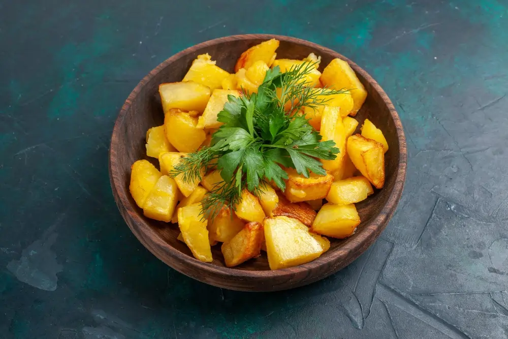 "Close-up of white sweet potato, showcasing its smooth, light-colored skin and creamy interior, placed on a rustic wooden surface."