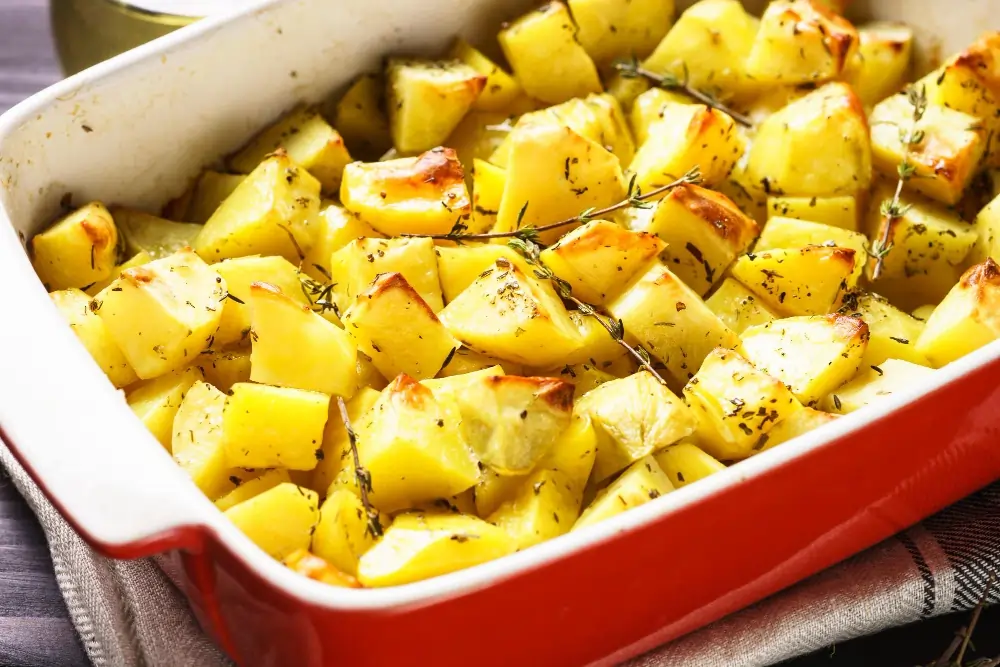 "Close-up of white sweet potato, showcasing its smooth, light-colored skin and creamy interior, placed on a rustic wooden surface."