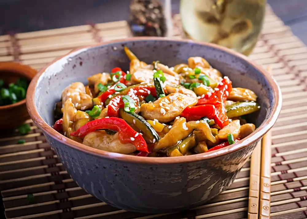 Spicy Chicken Bowl: A colorful bowl filled with tender spicy chicken, fluffy rice, fresh vegetables, and a sprinkle of herbs, showcasing a delicious and healthy meal.